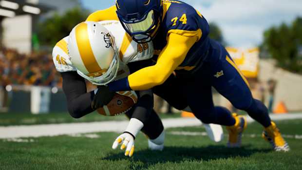 One football player tackling another to the ground.
